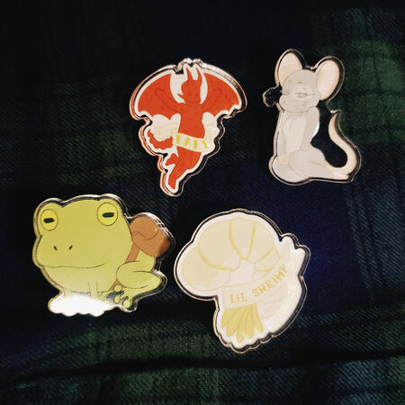 Acrylic pins featuring icons from the show Fantasy High.