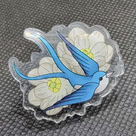 An acrylic pin featuring the starbird minion from Final Fantasy 14.